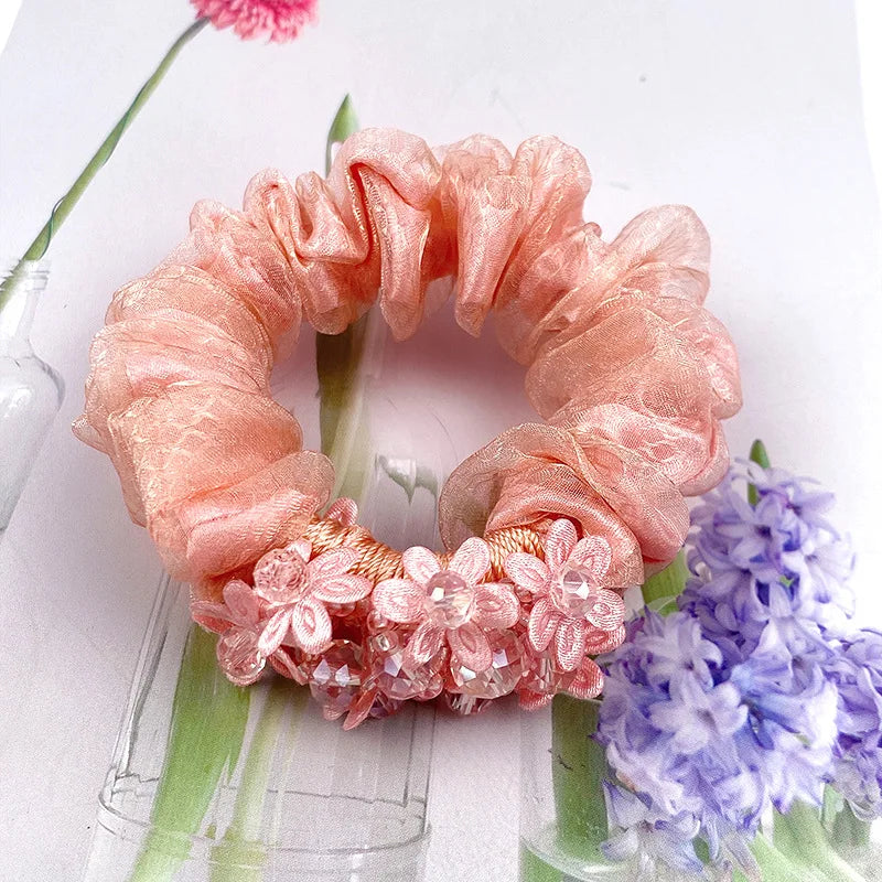 Dazzling Petal Elegance: Crystal-Embellished Floral Fabric Scrunchies. Hair accessories for brides.. Hair accessories in USA. Bride accessories in USA. Bridal hair accessories in USA. Kids hair accessories in USA. Girls hair accessories. Hair products. Beautiful hair accessories.