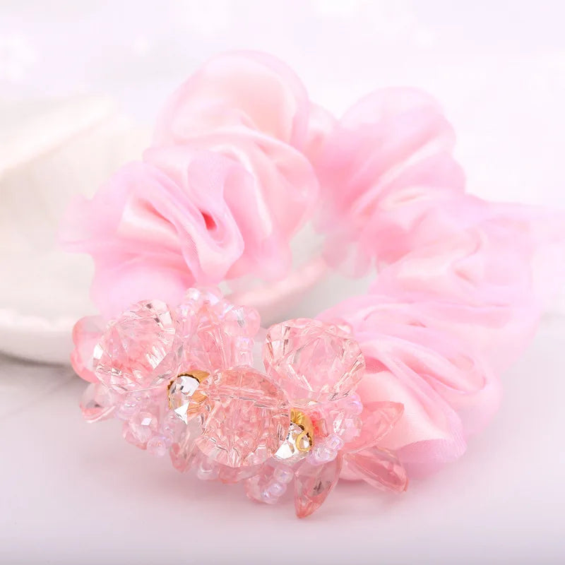 Dazzling Petal Elegance: Crystal-Embellished Floral Fabric Scrunchies. Hair accessories for brides.. Hair accessories in USA. Bride accessories in USA. Bridal hair accessories in USA. Kids hair accessories in USA. Girls hair accessories. Hair products. Beautiful hair accessories.