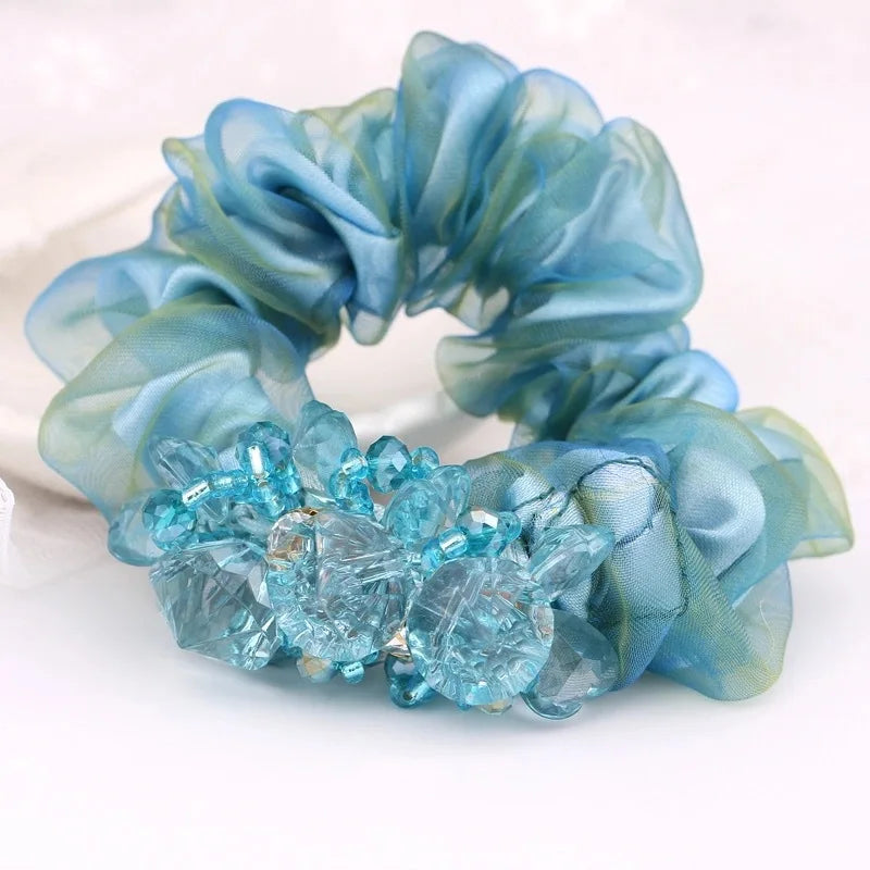 Dazzling Petal Elegance: Crystal-Embellished Floral Fabric Scrunchies. Hair accessories for brides.. Hair accessories in USA. Bride accessories in USA. Bridal hair accessories in USA. Kids hair accessories in USA. Girls hair accessories. Hair products. Beautiful hair accessories.