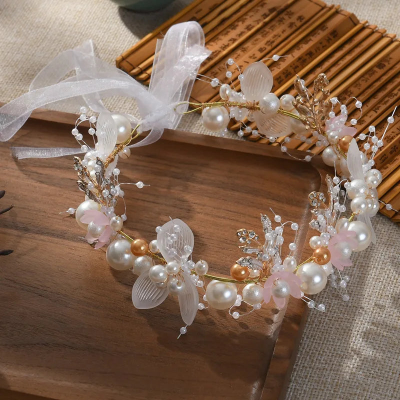 Pearl Petal Radiance: Elegant Floral Bridal Headband. Hairxza Hair Accessories. Hair accessories in USA. Bride accessories in USA. Bridal hair accessories in USA. Kids hair accessories in USA. Girls hair accessories. Hair products. Beautiful hair accessories