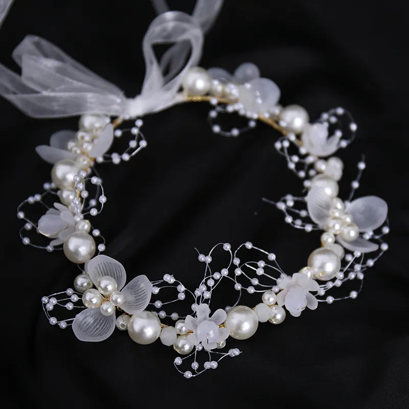 Pearl Petal Radiance: Elegant Floral Bridal Headband. Hairxza Hair Accessories. Hair accessories in USA. Bride accessories in USA. Bridal hair accessories in USA. Kids hair accessories in USA. Girls hair accessories. Hair products. Beautiful hair accessories