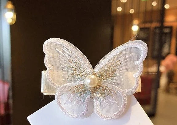 FlutterGlam Pearl Bloom: Enchanting Butterfly Rhinestone Tassel Headband. Hairxza Hair Accessories. Hair accessories in USA. Bride accessories in USA. Bridal hair accessories in USA. Kids hair accessories in USA. Girls hair accessories. Hair products. Beautiful hair accessories.