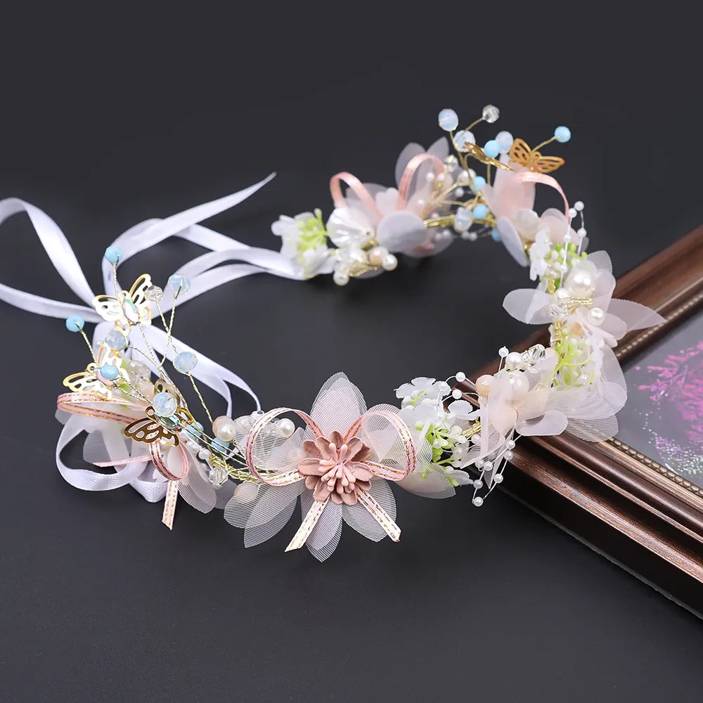 Pearl Petal Radiance: Elegant Floral Bridal Headband. Hairxza Hair Accessories. Hair accessories in USA. Bride accessories in USA. Bridal hair accessories in USA. Kids hair accessories in USA. Girls hair accessories. Hair products. Beautiful hair accessories