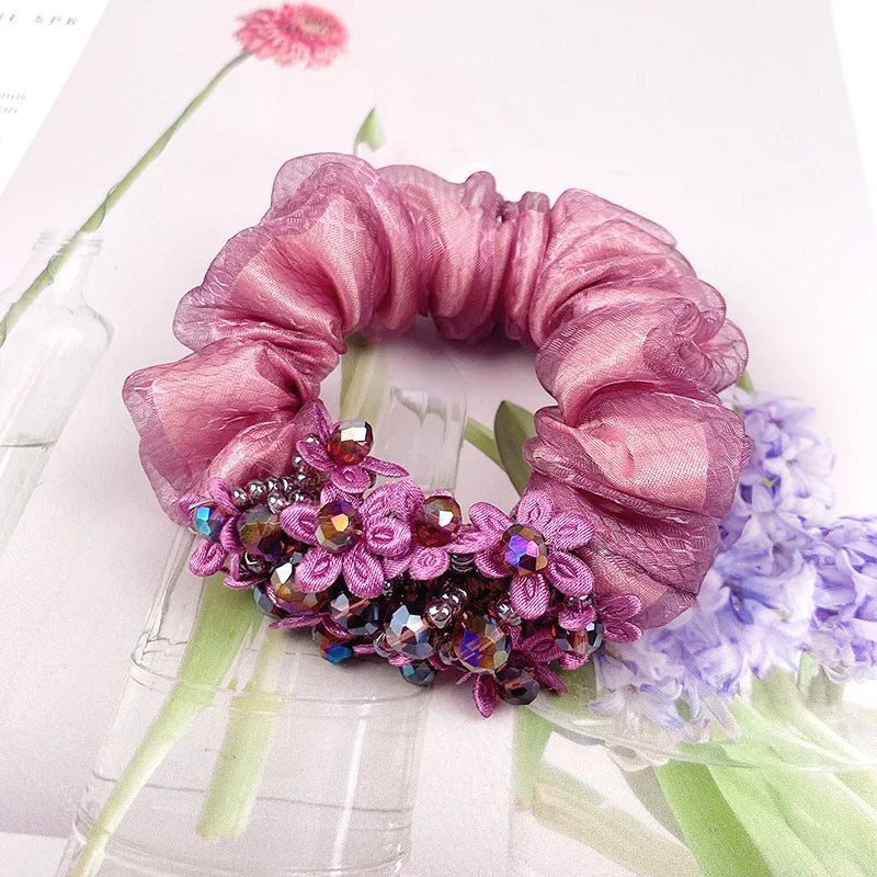 Dazzling Petal Elegance: Crystal-Embellished Floral Fabric Scrunchies. Hair accessories for brides.. Hair accessories in USA. Bride accessories in USA. Bridal hair accessories in USA. Kids hair accessories in USA. Girls hair accessories. Hair products. Beautiful hair accessories.