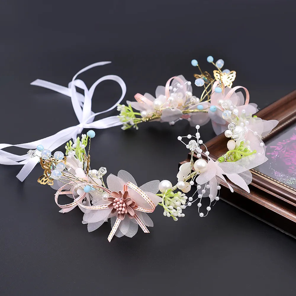 Pearl Petal Radiance: Elegant Floral Bridal Headband. Hairxza Hair Accessories. Hair accessories in USA. Bride accessories in USA. Bridal hair accessories in USA. Kids hair accessories in USA. Girls hair accessories. Hair products. Beautiful hair accessories